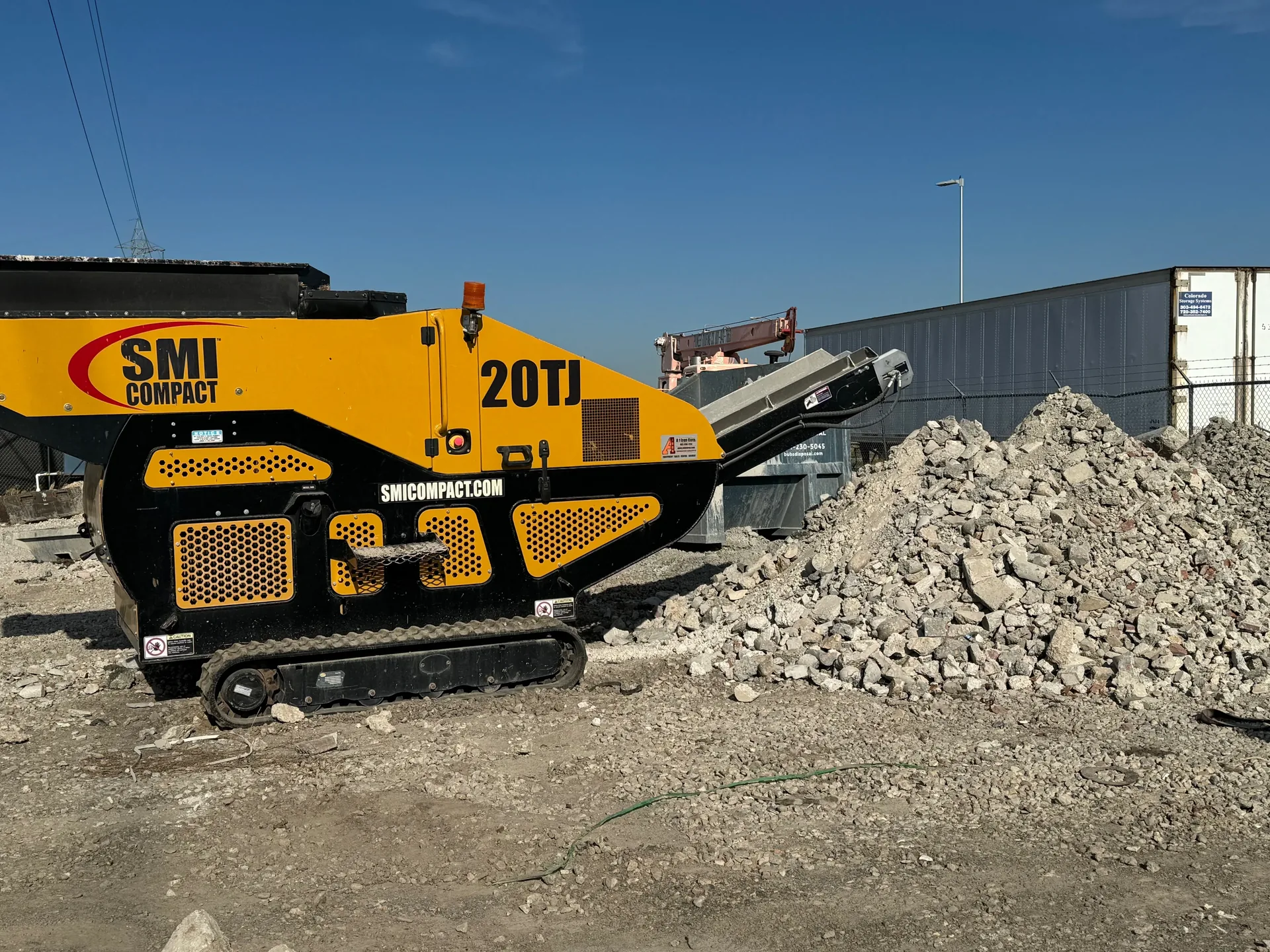 Bubs Disposal concrete crusher in action at the SLC yard with a pile of crushed aggregate