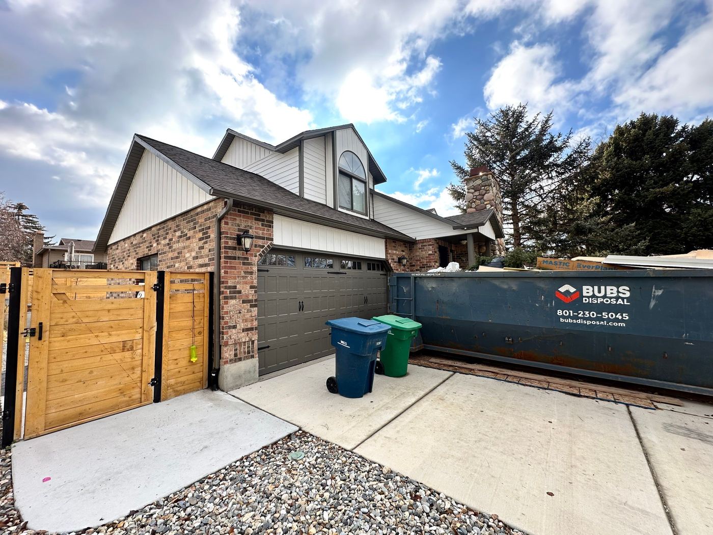 Bubs Disposal 30 yard dumpster in a home driveway in Sandy, Utah